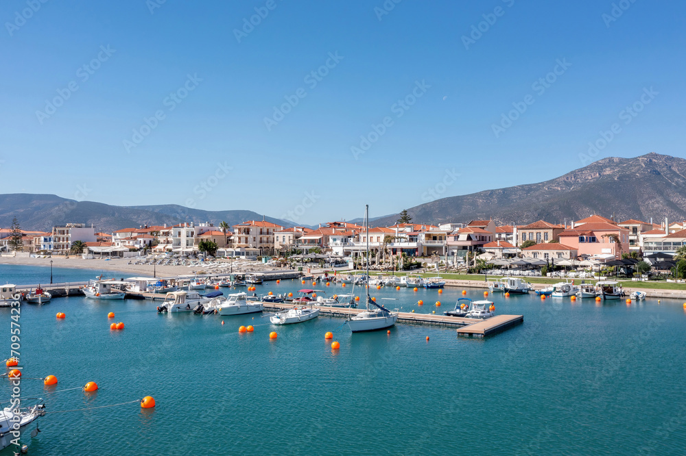 Peloponnese Paralio Astros port, Arcadia Greece. Aerial drone view of town, moored boat, buoy in sea