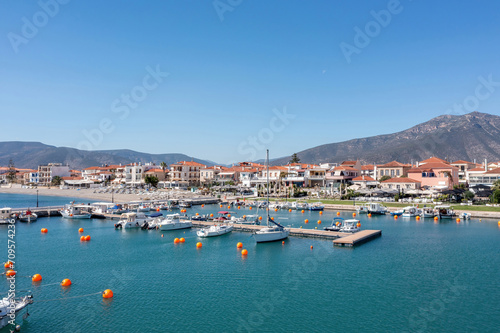 Peloponnese Paralio Astros port  Arcadia Greece. Aerial drone view of town  moored boat  buoy in sea