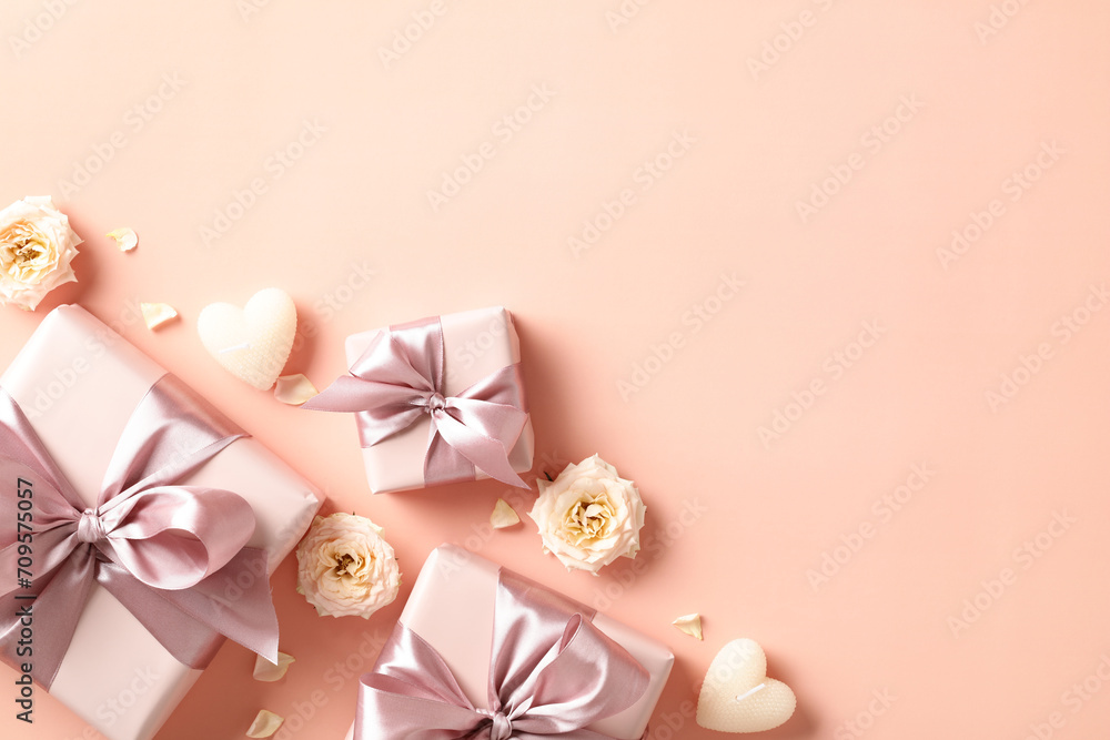 Happy Valentine's day flat lay composition with gift boxes, candles, flowers on beige background. Top view. Happy Valentine's day flat lay composition with gift boxes, candles, flowers on beige background. Top view.