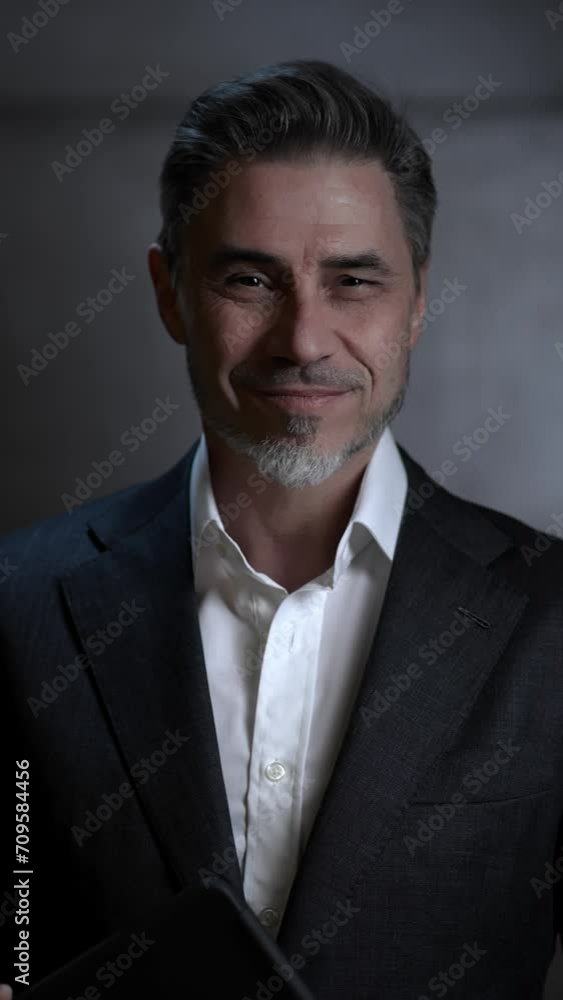 Portrait of happy mature businessman with tablet computer. Entrepreneur standing in front of dark loft wall. Older, middle aged, mid adult, man in his 40s or 50s in shirt and jacket, business casual. Portrait of happy mature businessman with tablet computer. Entrepreneur standing in front of dark loft wall. Older, middle aged, mid adult, man in his 40s or 50s in shirt and jacket, business casual.