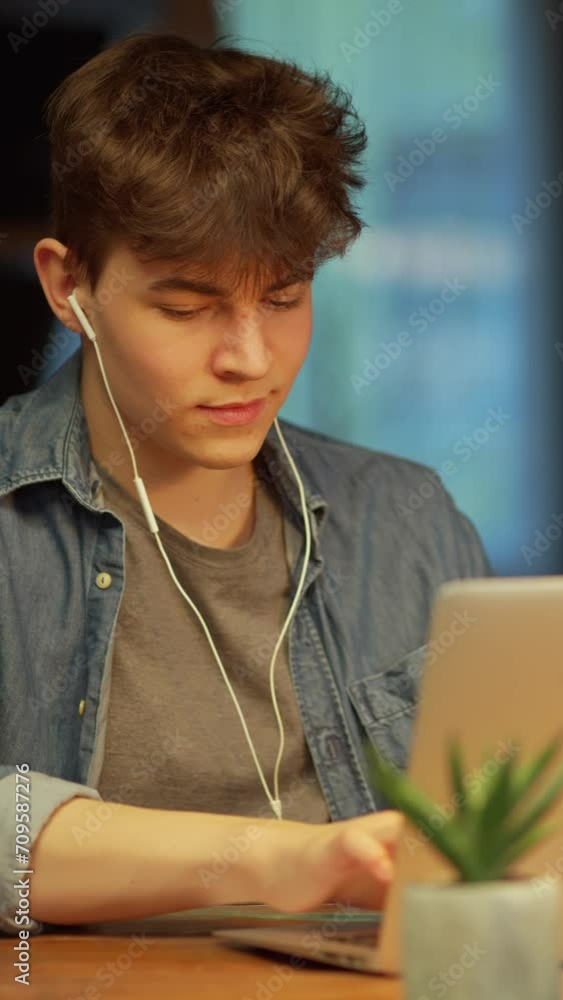 Teenage student learning at home with books and laptop computer. Online school and digital education, sitting at desk. Teenage student learning at home with books and laptop computer. Online school and digital education, sitting at desk.