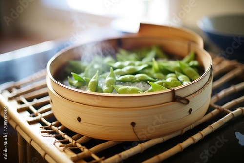 edamame in bamboo steamer, steaming process visible