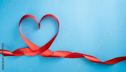 valentine day card or banner red heart of ribbon on blue background flat lay © Katherine
