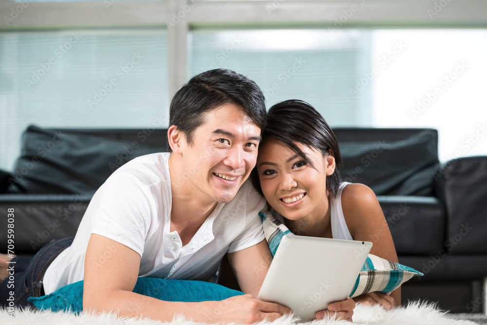 Obraz premium happy Asian woman using Digital Tablet at home