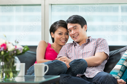 Happy Chinese couple at home together