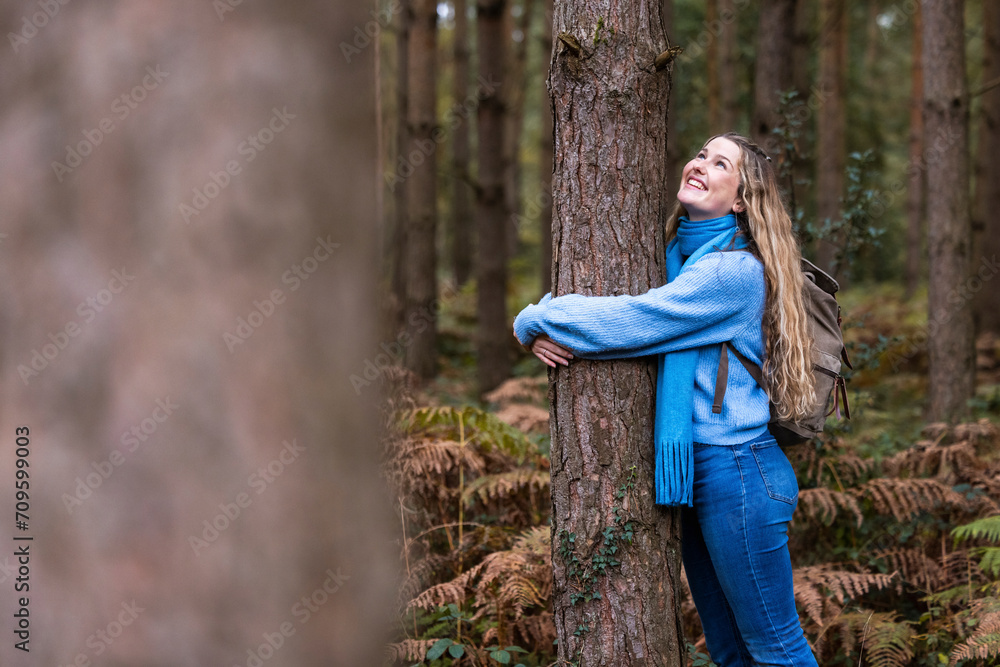 Smiling beautiful woman hugging tree in Cannock chase forest Smiling beautiful woman hugging tree in Cannock chase forest