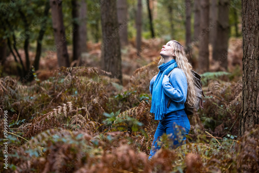 Smiling young woman with backpack in Cannock chase forest Smiling young woman with backpack in Cannock chase forest