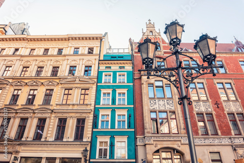 Poland, Lower Silesian Voivodeship, Wroclaw, Street light in front of row of historic houses