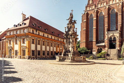 Poland, LowerSilesianVoivodeship, Wroclaw,Statue of John of Nepomuk in front of Collegiate Church of Holy Cross and St Bartholomew photo