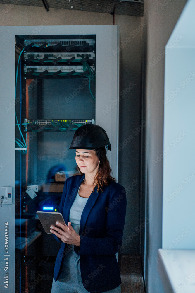 Architect using tablet PC standing in workshop Architect using tablet PC standing in workshop