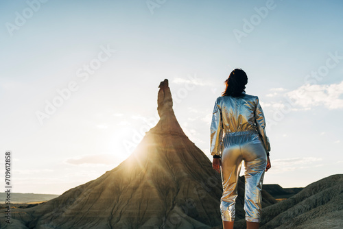 Woman in shiny clothing admiring Castildetierra at sunset photo
