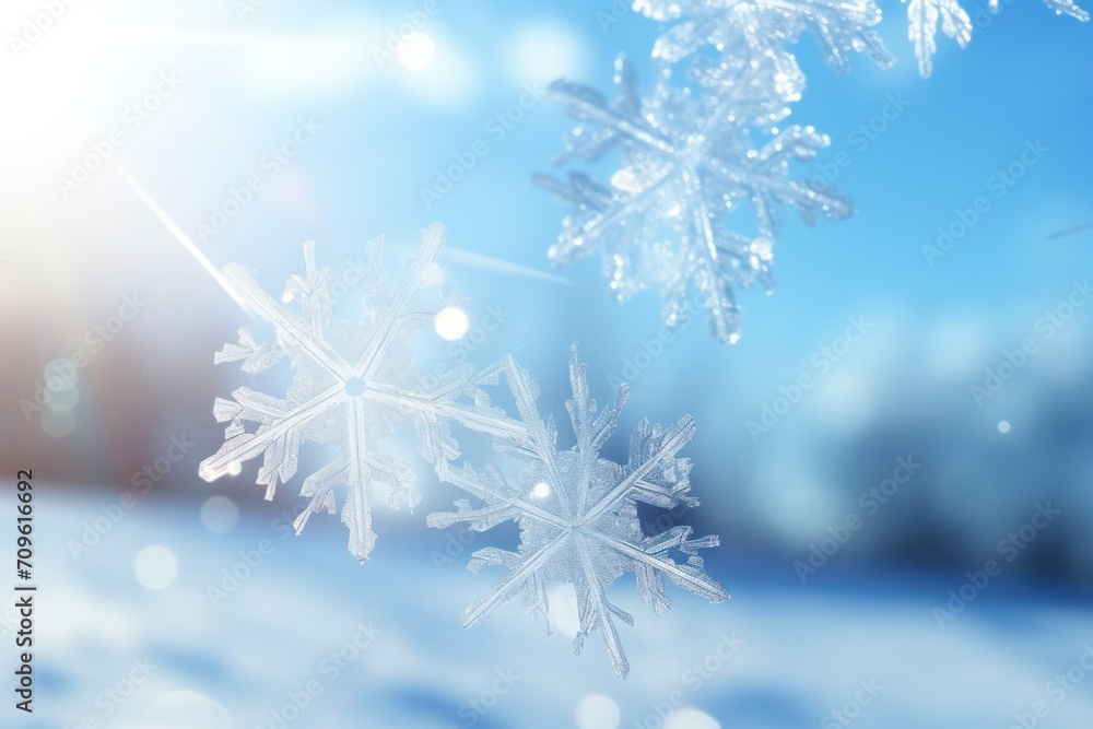 a close up of a snowflake on a sunny day with a blurry blue sky in the background. a close up of a snowflake on a sunny day with a blurry blue sky in the background.