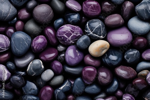  a pile of purple and black rocks with a yellow rock in the middle of the pile on top of them.