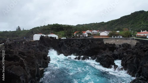 Aerial footage approaching Varadouro natural pool volcanic rocks, Faial, Azores photo