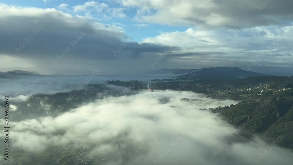Real time approach to a mountanious airport surrounded by patches of fog. VIgo, Spain. As seen by the pilots in a real flight. A pilot’s perspective. Real time approach to a mountanious airport surrounded by patches of fog. VIgo, Spain. As seen by the pilots in a real flight. A pilot’s perspective.