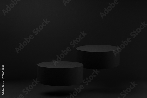 Two black round podiums levitate, mockup on black background with shadow. Template for presentation cosmetic products, gifts, goods, advertising, design, display, showing in elegant fashion style.