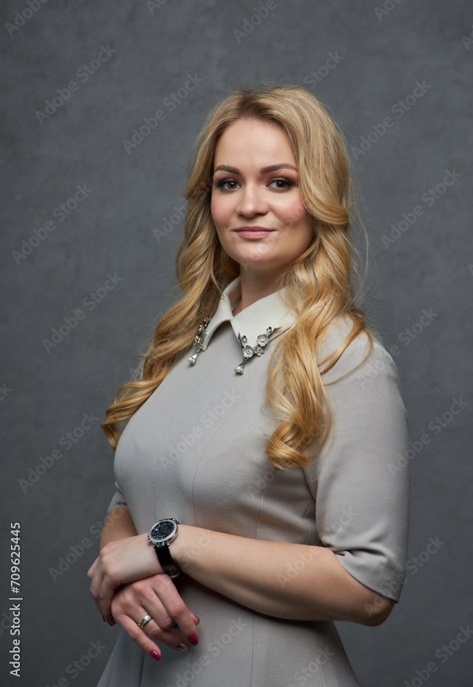 Portrait of an attractive woman, shot in the studio against a grey background Portrait of an attractive woman, shot in the studio against a grey background