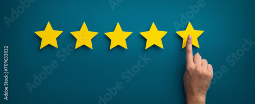 Woman hand showing on five star excellent rating photo