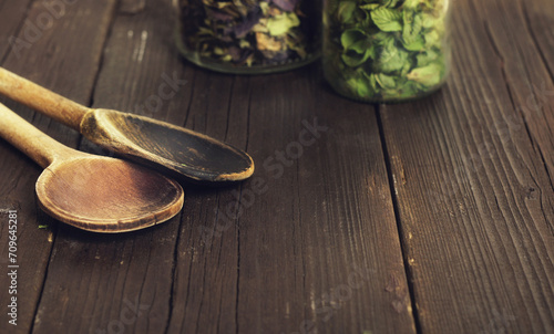 Dry herbs and kitchen wooden spoons