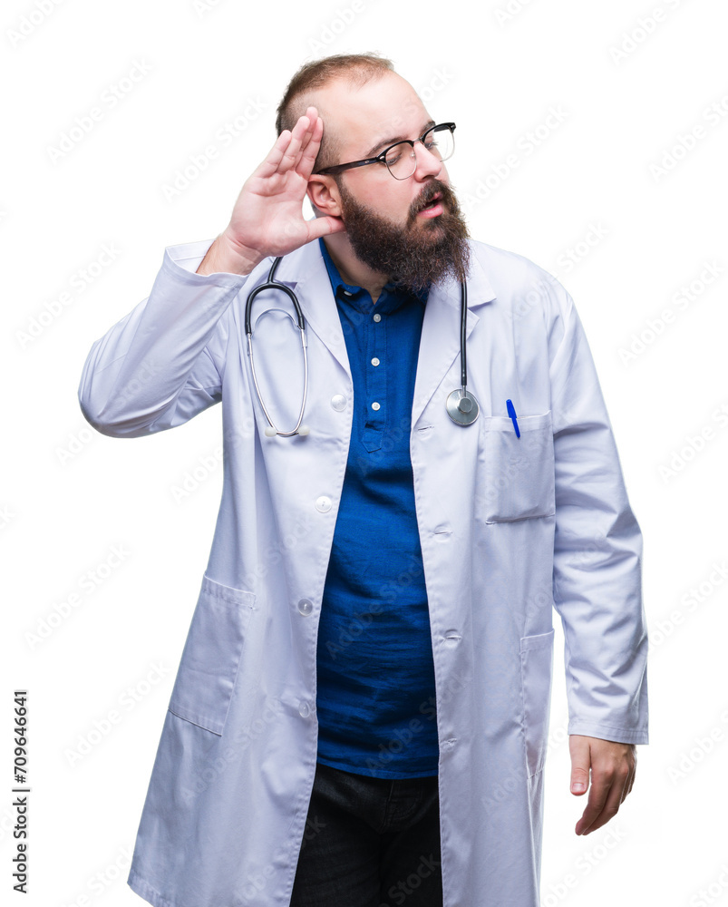 Young caucasian doctor man wearing medical white coat over isolated background smiling with hand over ear listening an hearing to rumor or gossip. Deafness concept. Young caucasian doctor man wearing medical white coat over isolated background smiling with hand over ear listening an hearing to rumor or gossip. Deafness concept.