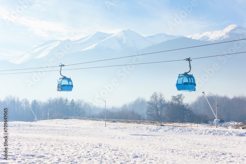 Bansko, Bulgaria Bulgarian winter ski resort panorama with gondola lift cabins, Pirin mountain peaks view photo
