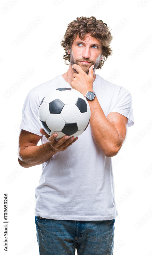 Handsome hispanic man model holding soccer football ball over isolated background serious face thinking about question, very confused idea