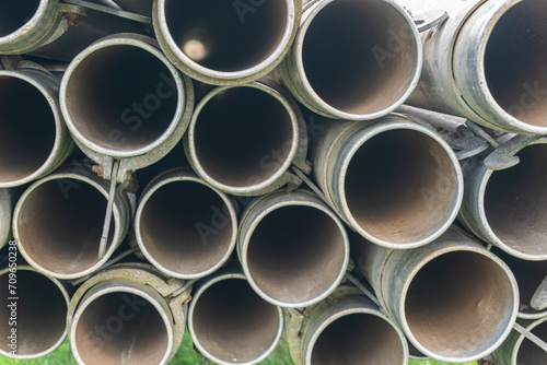 A lot of straight metal pipes  tubes loaded on a trailer