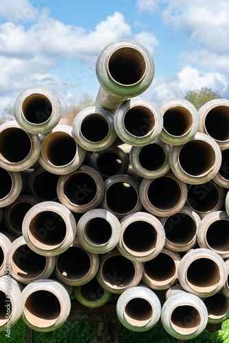 A lot of straight metal pipes, tubes loaded on a trailer