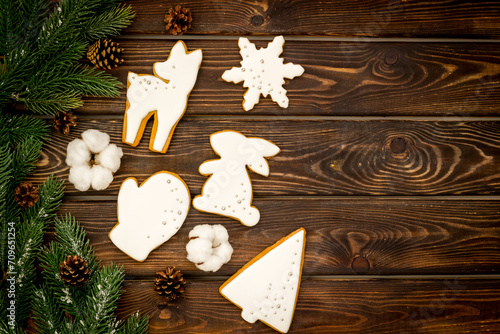 White Christmas cookies with fir tree branches, top view. New Year decoration