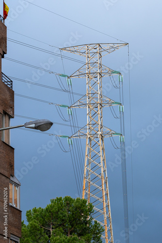 High voltage cable tower with a cloudy sky before a storm photo