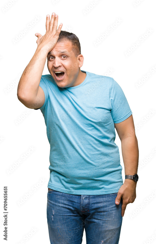 Middle age arab man wearing blue t-shirt over isolated background surprised with hand on head for mistake, remember error. Forgot, bad memory concept.