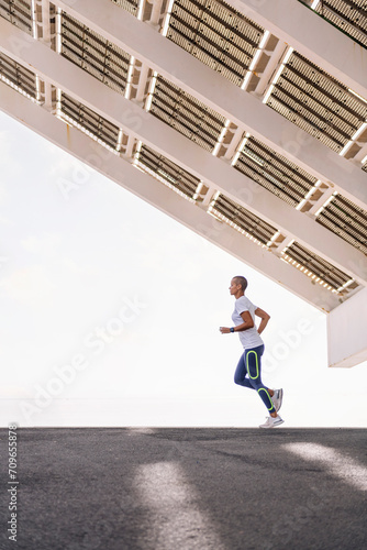 young sports woman with shaved head practicing running, concept of active and healthy lifestyle, copy space for text © Raul Mellado