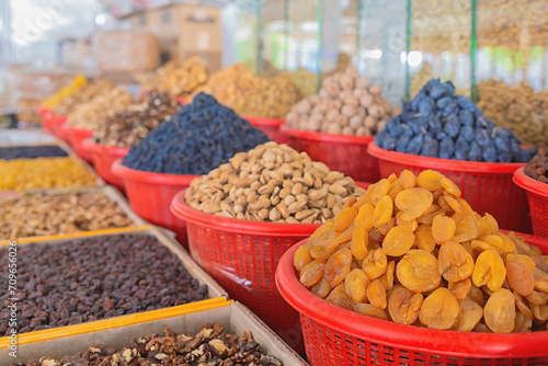 Colorful dried fruits and nuts at the Siab or Siyob bazaar (Siyob bozori). Samarkand, Uzbekistan, Central Asia photo