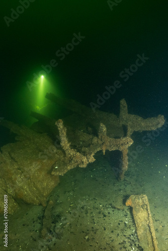 adventurous scuba divers explore submerged wreckage of the sunken shipwreck Archimedes in Dutch cold saltwater scuba dive site oostvoornse meer oostvoorne