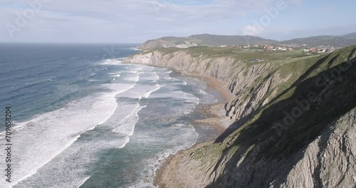 Aerial drone shot of Atlantic Ocean waves coming into shore at beach in Sopela outside of Bilbao, Basque, Spain, Europe. Shot in ProRes 422 HQ photo