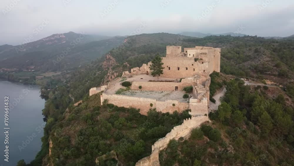 Drone view of Miravet Castle and Ebro River on foggy day Drone view of Miravet Castle and Ebro River on foggy day