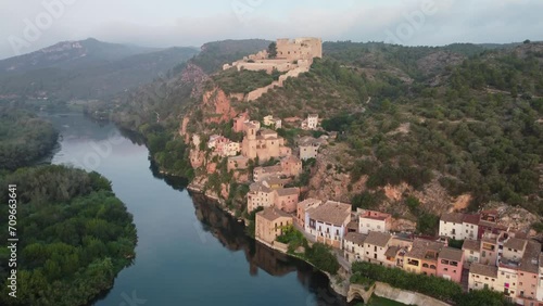 Miravet Castle and riverside town at Ebro River shore. Tarragona. photo