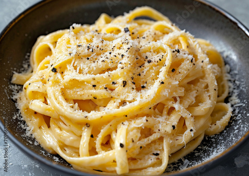A creamy pasta dish with grated parmesan from a 45-degree angle, using soft sidelight for a comforting atmosphere. 