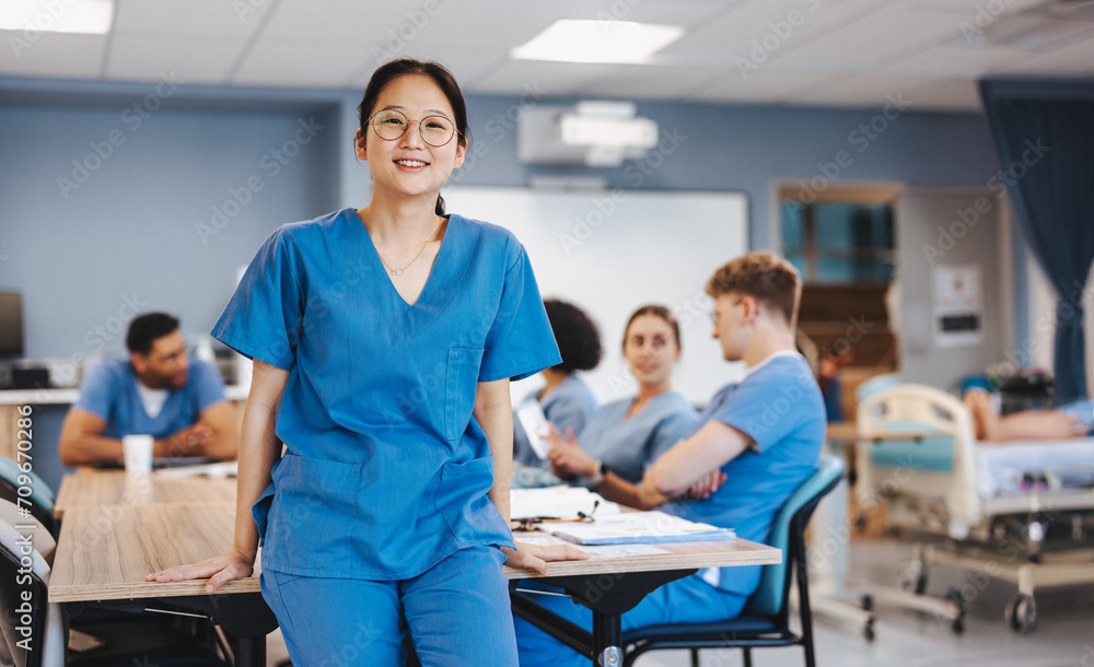 Young Asian student wearing medical scrubs in a teaching hospital Young Asian student wearing medical scrubs in a teaching hospital