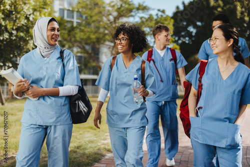 Multicultural medical campus: Happy students going to class together photo