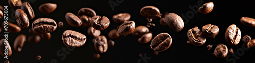 a falling coffee bean banner, roasted coffee bean on the air isolated on a black background, International Coffee Day concept