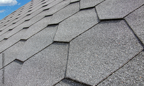 Asphalt hexagonal gray shingle roof tile closeup