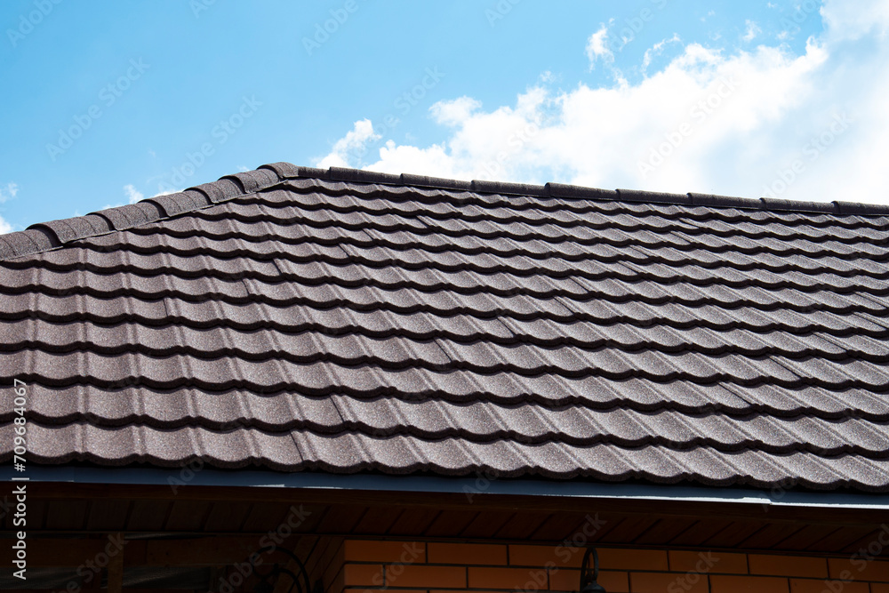 Composite roof tile on house against blue sky