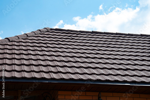 Composite roof tile on house against blue sky
