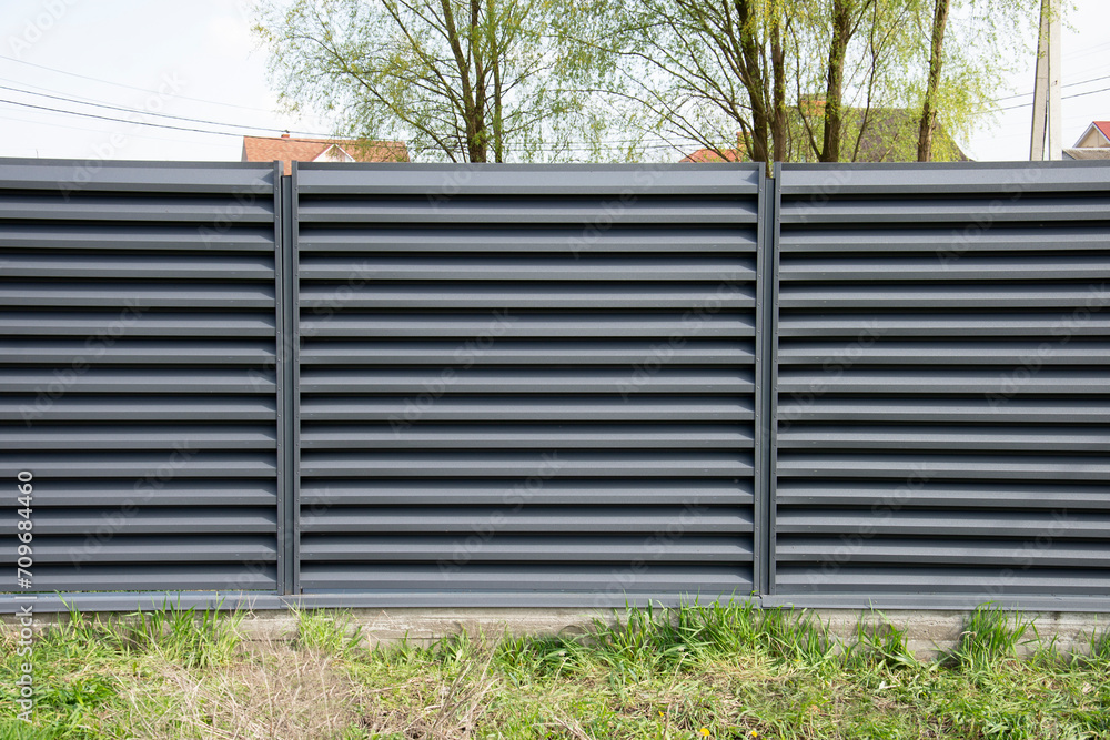 Modern metal profile fence with shutters or blinds Modern metal profile fence with shutters or blinds