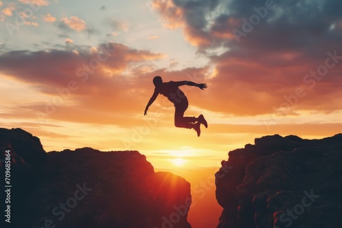 A daring individual leaps off a cliff into the vibrant colors of the setting sun. Perfect for adventure and thrill-seeking concepts
