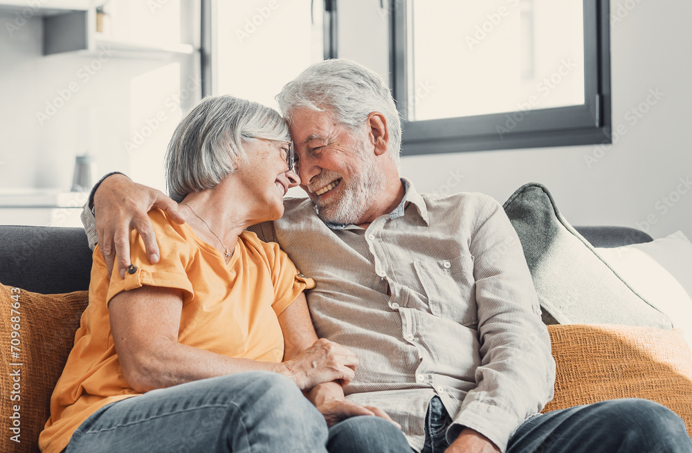 Happy laughing older married couple talking, laughing, standing in home interior together, hugging with love, enjoying close relationships, trust, support, care, feeling joy, tenderness. Happy laughing older married couple talking, laughing, standing in home interior together, hugging with love, enjoying close relationships, trust, support, care, feeling joy, tenderness.