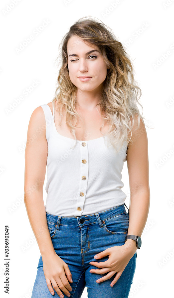 Young beautiful blonde woman over isolated background winking looking at the camera with sexy expression, cheerful and happy face. Young beautiful blonde woman over isolated background winking looking at the camera with sexy expression, cheerful and happy face.
