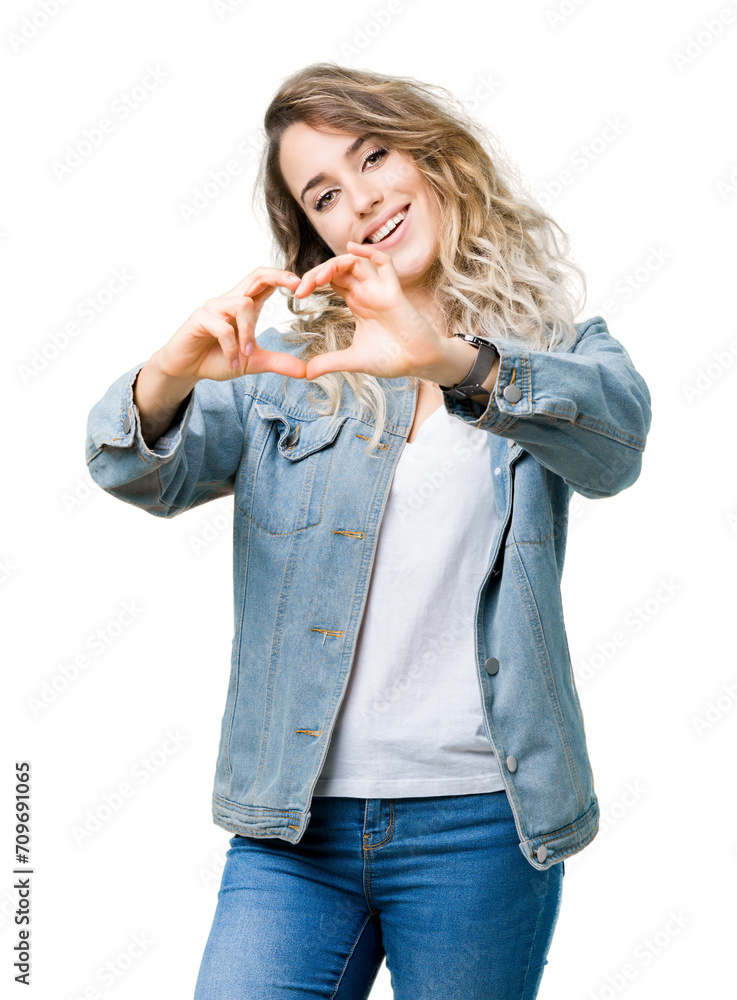 Beautiful young blonde woman wearing denim jacket over isolated background smiling in love showing heart symbol and shape with hands. Romantic concept. Beautiful young blonde woman wearing denim jacket over isolated background smiling in love showing heart symbol and shape with hands. Romantic concept.