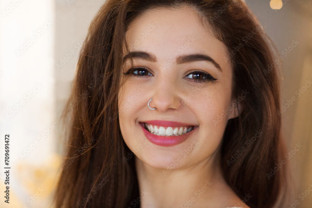 Portrait of young brunette girl with nose earring Portrait of young brunette girl with nose earring